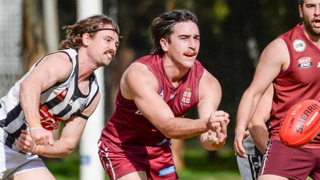 PAOC’s Thomas Fisher handballs as the Old Reds smashed PNU at Park 9 on Saturday. Picture: Brenton Edwards