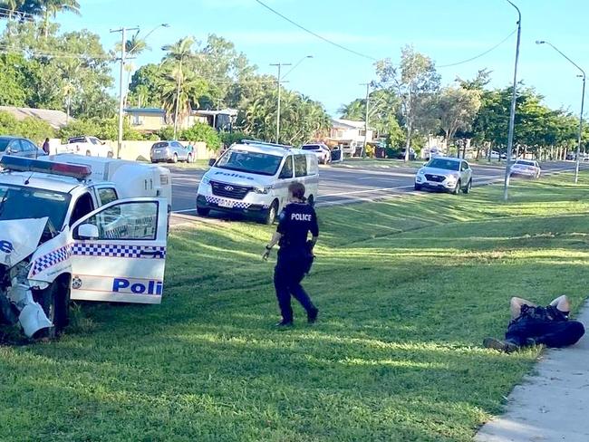 An injured police officer lies on the ground following Townsville after being hit by a stolen car allegedly full of children. Picture: Supplied