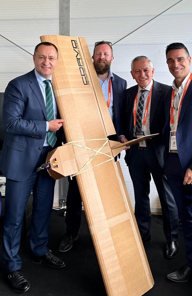 Ukrainian Ambassador Vasyl Myroshnychenko (L) with the Australian-made Precision Payload Delivery System drone and SYPAQ representatives, (L-R) SYPAQ chief engineer Ross Osborne, founder and chairman George Vicino and managing director David Vicino.