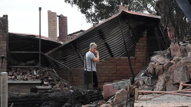 Deb Nave looks the remains of her Tathra home. Picture: AAP/Dean Lewins