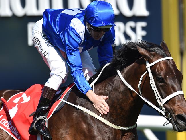 High Bowman gives Winx a well-deserved pat after she delivers in the Caulfield Stakes. Picture: AAP