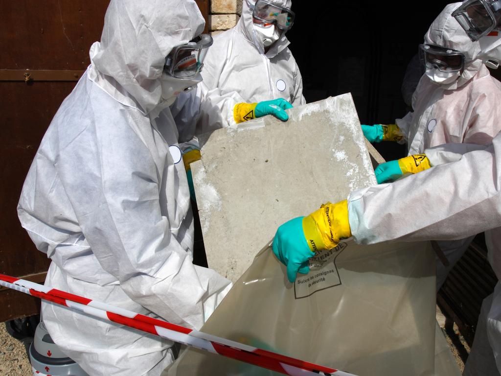 Workers don the full protective equipment needed to handle asbestos. Picture: iStock