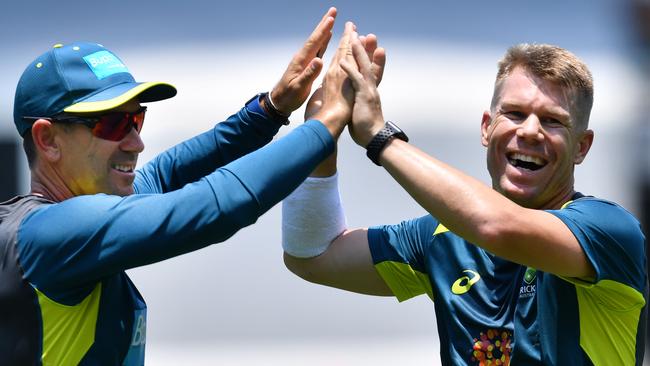 Australian coach Justin Langer (left) with opener David Warner at training. Picture: AAP