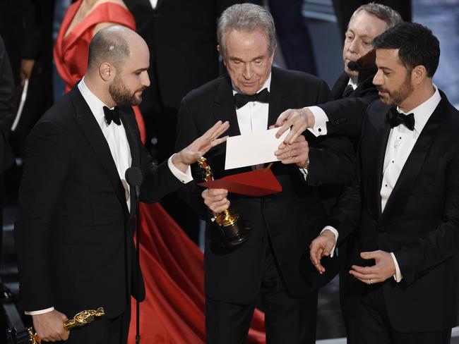 La La Land producer Jordan Horowitz presenter Warren Beatty and host Jimmy Kimmel look at the new envelope. Picture: Chris Pizzello/Invision/AP