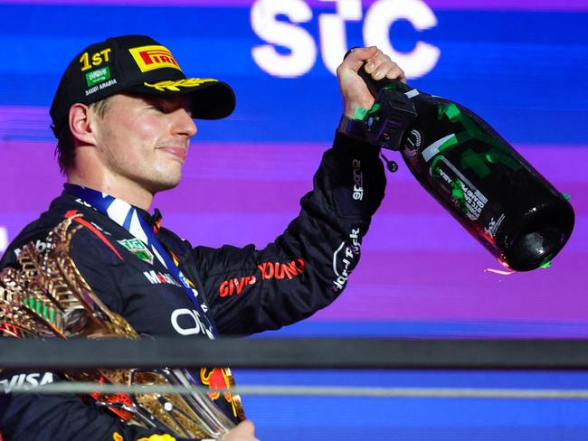 Red Bull Racing's Dutch driver Max Verstappen celebrates during the podium ceremony after winning the Saudi Arabian Formula One Grand Prix at the Jeddah Corniche Circuit in Jeddah on March 9, 2024. (Photo by Giuseppe CACACE / AFP)