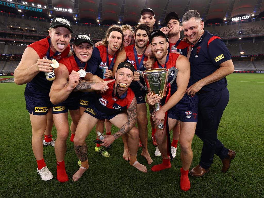 Melbourne midfield coach Adan Yze celebrates with some of his charges. Picture: Michael Klein