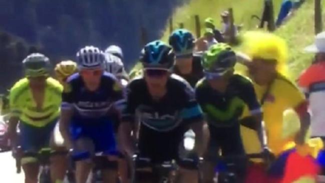 Chris Froome (second rider from right) punches a Colombian fan in the face during stage eight of the Tour de France.