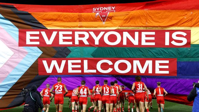 The Swans run through their banner for the 2022 Pride Game against St Kilda. Picture: Phil Hillyard