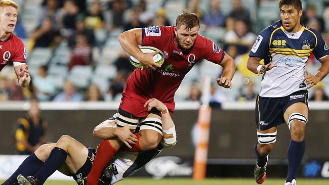 CANBERRA, AUSTRALIA - FEBRUARY 13: Curtis Browning of the Reds is tackled during the round one Super Rugby match between the Brumbies and the Reds at GIO Stadium on February 13, 2015 in Canberra, Australia. (Photo by Stefan Postles/Getty Images)