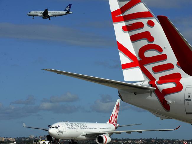 Two planes sporting the new branding for the Virgin Australia airline, replacing Virgin Blue and V Australia brands at Sydney Airport, Sydney, Wednesday, May 4, 2011. (AAP Image/Dean Lewins) NO ARCHIVING