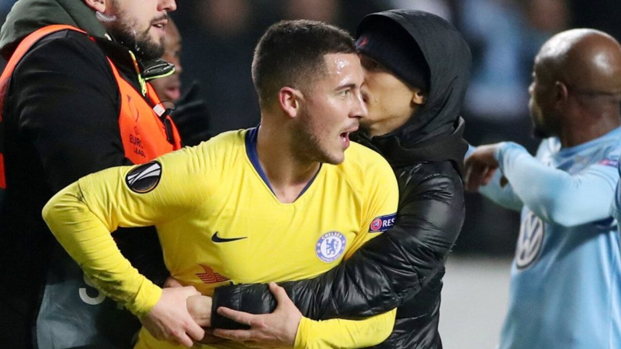 Eden Hazard is grabbed from behind by a pitch invader