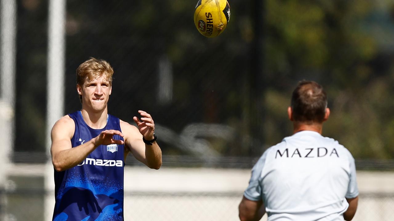 North Melbourne shuttle run winner Dylan Stephens with coach Alastair Clarkson on the first day of the Kangaroos’ pre-season training at Arden Street on Monday. Picture: Michael Willson / Getty Images