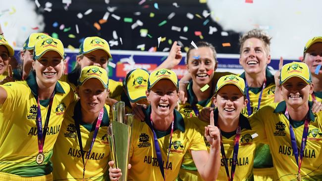 Captain Meg Lanning (centre) and the Australian team celebrate with the trophy during the ICC Women's World T20 2018 final between Australia and England. Photo: Getty Images.