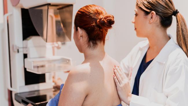 Doctor doing mammogram exam on patient at hospital