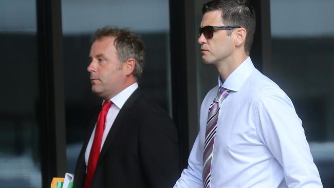 AFL Cairns player Daniel Lock, right, arriving at Cairns court to face charges of grievous bodily harm. PICTURE: STEWART McLEAN