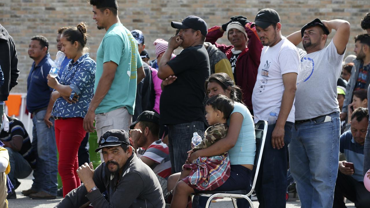 Central American migrants line up to register with Mexican immigration officials at the shelter in Piedras Negras, Mexico. Picture: Jerry Lara