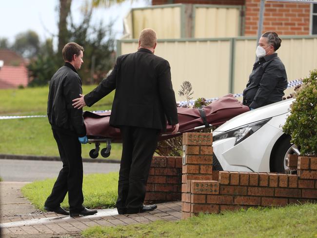 The body of one of the pair was removed from the scene. Picture: John Grainger