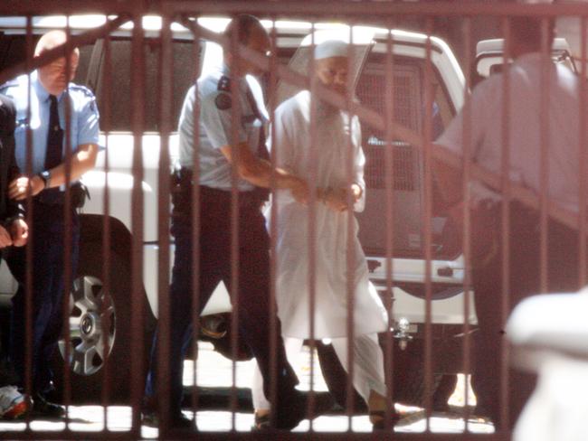 Abdul Nacer Benbrika is escorted from the Victorian Supreme Court after his conviction and sentencing on terrorism charges.
