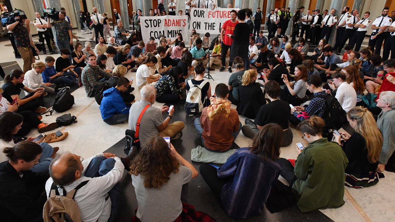 Students and activists, protesting climate change, stage a sit-in in the marble foyer at Parliament House. Picture: AAP