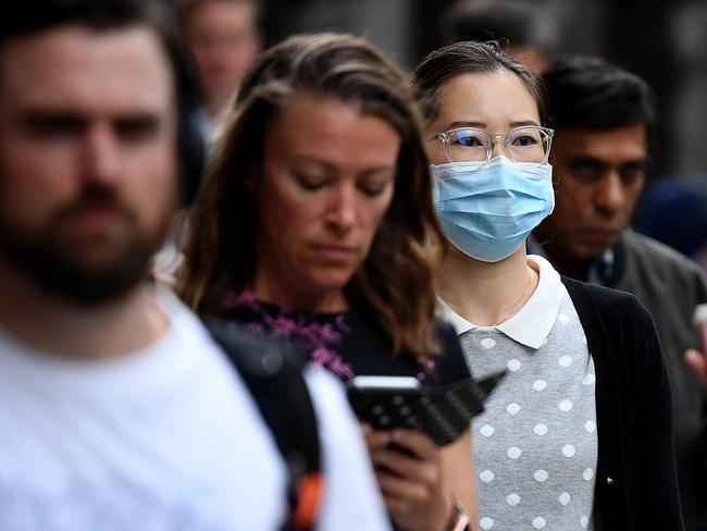 A woman wearing a face mask as a preventative measure against coronavirus COVID-19 in Sydney, Monday, March 16, 2020. (AAP Image/Joel Carrett) NO ARCHIVING