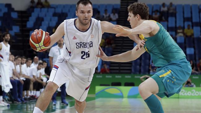 Serbia's Milan Macvan (25) drives past Australia's Cameron Bairstow, right, during a basketball game at the 2016 Summer Olympics in Rio de Janeiro, Brazil, Monday, Aug. 8, 2016. (AP Photo/Charlie Neibergall)