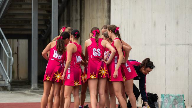 MBC netball players rally at a break. photographer David Pearce.