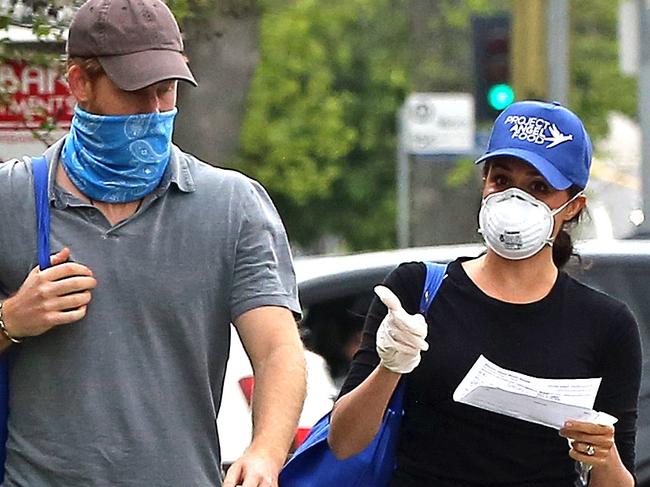 ONE TIME WEB USE FOR NEWS.COM.AU STORY ONLY - FEES APPLY FOR REUSE - SPEAK TO YOUR PIC ED BEFORE USING -  *PREMIUM EXCLUSIVE* Prince Harry and Meghan Markle are seen in LA wearing masks as they deliver meals to residents in need during the COVID-19 pandemic. The couple were pictured delivering packages after volunteering with the non-profit organisation â€˜Project Angel Foodâ€™. The former Duke and Duchess of Sussex were seen linking arms and holding hands after dropping off deliveries to addresses in their new city. Mandatory Credit: P&P/Rachpoot/MEGA. 17 Apr 2020 Pictured: Prince Harry and Meghan Markle. Photo credit: P&P/Rachpoot/MEGA TheMegaAgency.com +1 888 505 6342 (Mega Agency TagID: MEGA649042_068.jpg) [Photo via Mega Agency]  Picture: P&P/Rachpoot/MEGA