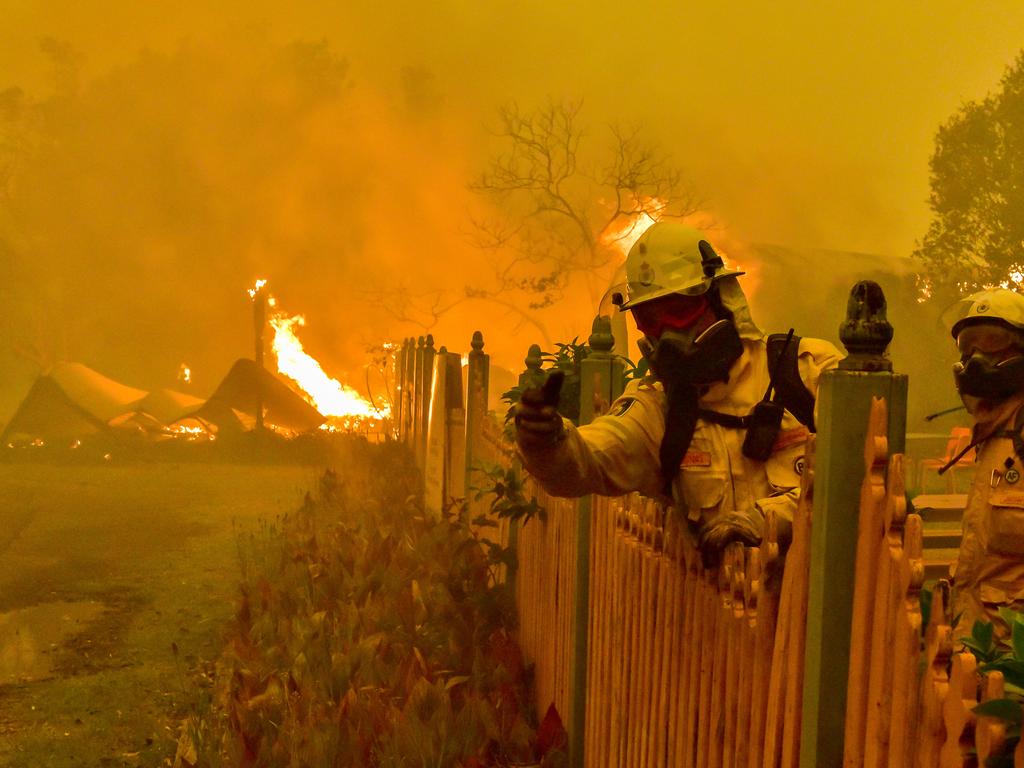 The Gospers Mountain fire continues to be listed at Emergency Warning Level. Tutti Frutti Fruit Shop on Bells Lin elf Road has been destroyed, along with the adjoining house and the neighbouring house. Several sheds have been damaged also. Firefighter scramble to save the fruit shop. Picture: Matrix