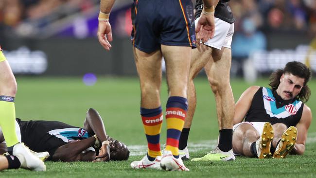 Aliir Aliir (L) grimaces after the collision. Picture: Sarah Reed/AFL Photos via Getty