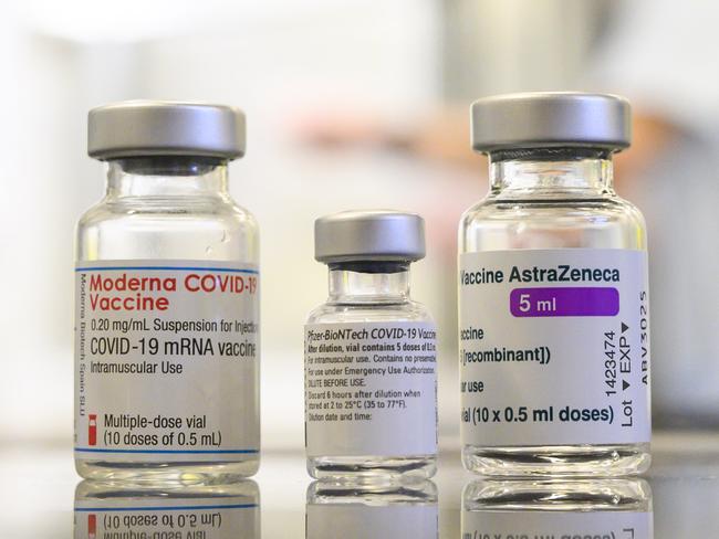 Three vials with different vaccines against Covid-19 by (L-R) Moderna, Pfizer-BioNTech and AstraZeneca stand on a table in the pharmacy of the vaccination center at the Robert Bosch hospital in Stuttgart, southern Germany, on February 12, 2021, amid the novel coronavirus / COVID-19 pandemic. (Photo by THOMAS KIENZLE / AFP)