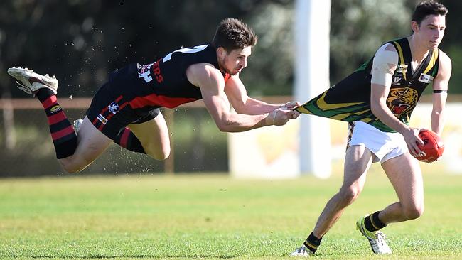 Gotcha: Frankston Bomber Dale Sutton grabs the jumper of Dromana's Jordan McCulley. Picture: Jason Sammon.