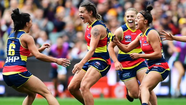 Hannah Martin, left, celebrates a goal in the grand final with Anne Hatchard and Justine Mules. Picture: Mark Brake/Getty Images