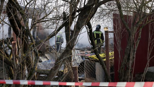 Rescuers work to extinguish a fire in a house following a drone attack in the village of Stanovoye, Moscow region, on November 10. Picture: AFP