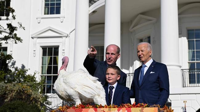 US President Joe Biden alongside Chair of the National Turkey Federation John Zimmerman and his son Grant during an event on the South Lawn of the White House in Washington, DC. Picture: AFP