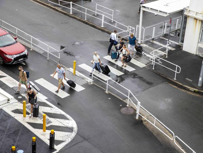 SYDNEY, AUSTRALIA - NewsWire Photos FEBRUARY 13, 2021: People are seen walking towards the Uber pick up point at Sydney Airport in Mascot after Melbourne entered a fresh lockdown at midnight. Picture: NCA NewsWire / Jenny Evans