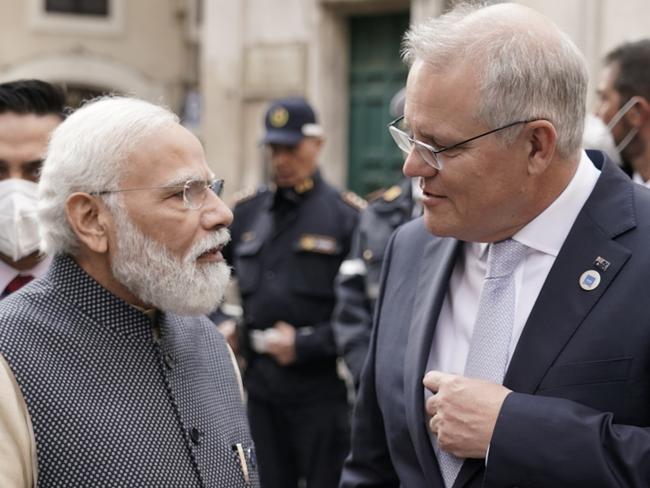 Australian Prime Minister Scott Morrison and Indian President Nerandra Modi talk before the G20 leaders make a short visit to the Fontana di Trevi to throw a coin in the fountain to make a wish before the start of the second day of the G20 in Rome on Sunday, October 31, 2021. Picture: Adam Taylor