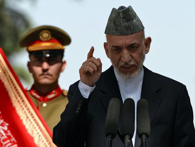 Afghanistan president Hamid Karzai gestures during a press conference at the presidential palace in Kabul on October 7, 2013. A field of divisive candidates for Afghanistan's 2014 election raised concerns of a repeat of the chaotic last presidential poll as the country seeks a stable end to the foreign military presence. AFP PHOTO/ Massoud HOSSAINI