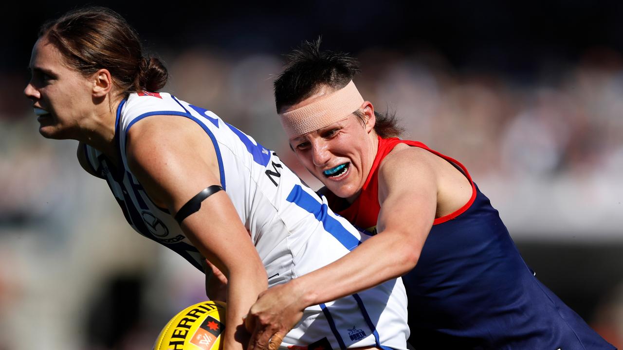 Jasmine Garner is tackled by Melbourne warrior Karen Paxman. Picture: Dylan Burns/AFL Photos via Getty Images