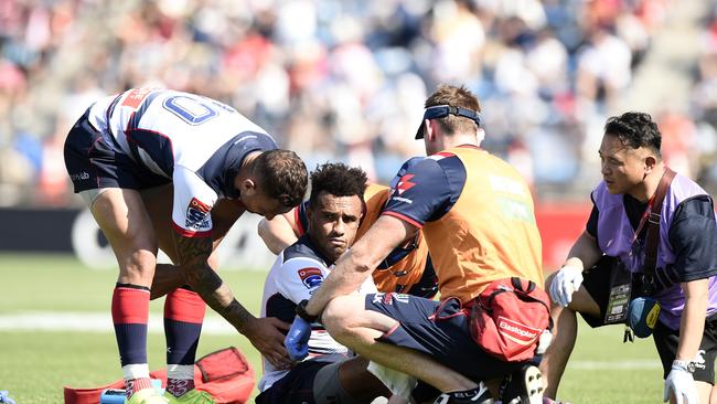 Quade Cooper checks on a groggy Will Genia. Picture: Getty