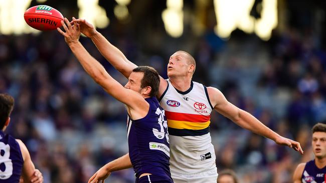 Sam Jacobs battles Michael Apeness in the ruck.