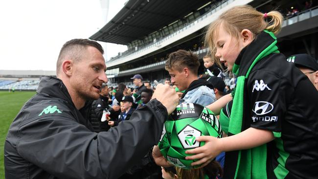 Western United striker Besart Berisha signs an autograph for a fan at GMHBA Stadium