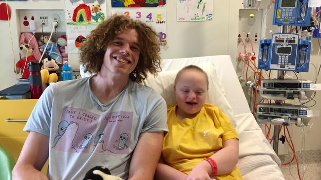 North Melbourne footy star Ben Brown and his cousin, Grace, who has spent time at the Royal Children's Hospital over the past 6 years.