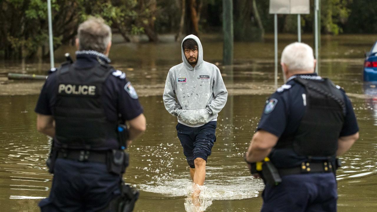 Police wait to speak to the man as he walks into shallower water. Picture: Richard Walker