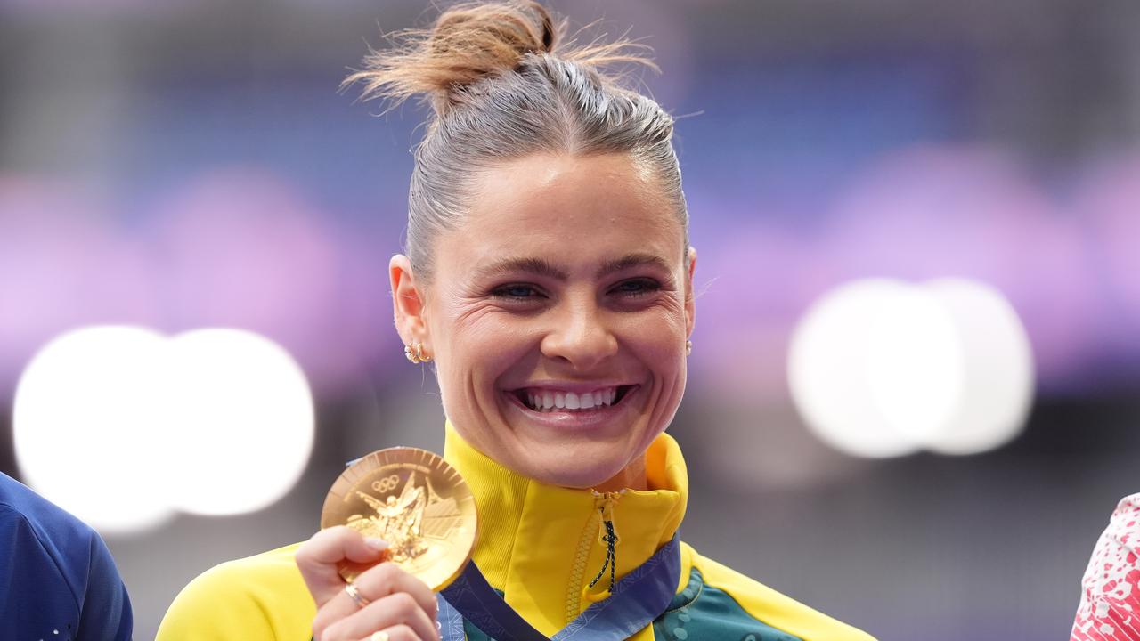 Gold medallist Australian pole vaulter Nina Kennedy poses with her gold medal on the podium after she won the Women's Pole Vault Final at the Stade de France in Saint-Denis, as part of the 2024 Paris Summer Olympic Games in, France, Thursday, August 08, 2024. (AAP Image/Dean Lewins) NO ARCHIVING