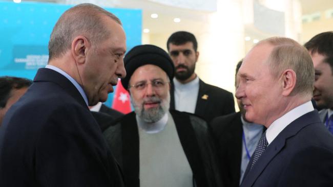 Turkish President Recep Tayyip Erdogan (left) speaks with Russian President Vladimir Putin (right) and Iranian President Ebrahim Raisi. Picture: AFP