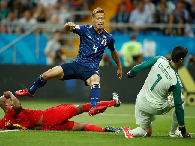 Japan's midfielder Keisuke Honda (top) vies with Belgium's defender Vincent Kompany in front of Belgium's goalkeeper Thibaut Courtois during the Russia 2018 World Cup round of 16 football match between Belgium and Japan at the Rostov Arena in Rostov-On-Don on July 2, 2018. / AFP PHOTO / Odd ANDERSEN / RESTRICTED TO EDITORIAL USE - NO MOBILE PUSH ALERTS/DOWNLOADS
