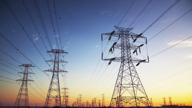 Power cables going in to the distance at dusk.