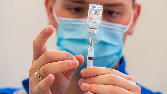 Registered nurse Frederick Morley loads syringes with the Modern vaccine in the US. Picture/ AFP