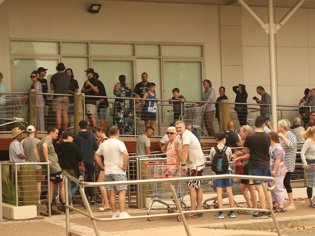 People queue for non-refrigerated food at the Batemans Bay Coles. Picture: John Grainger