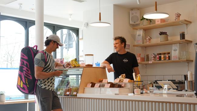 Urban Baristas' cafe owner Huw Wardrope serving a customer in his South Kensington store in London. Source: Supplied.